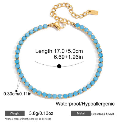 Blue beaded bracelet with gold chain and measurements on a white background